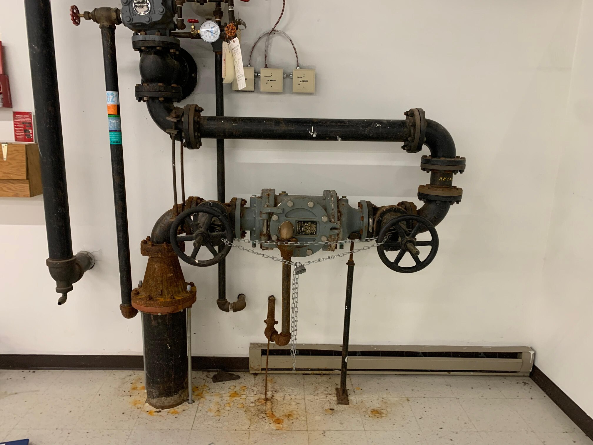 Old vs. repaired backflow preventer showing wear and corrosion.