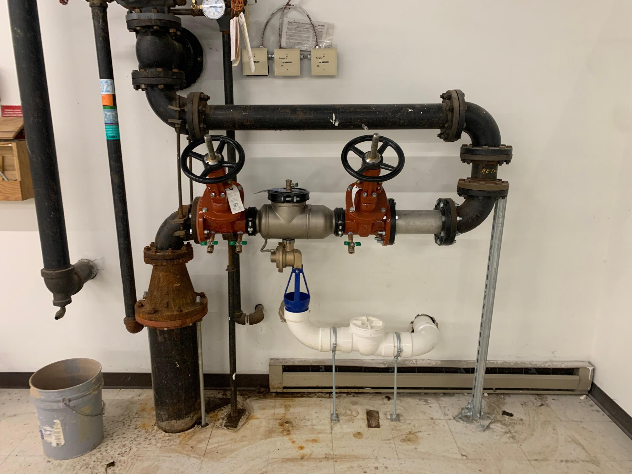 Old vs. repaired backflow preventer showing wear and corrosion.